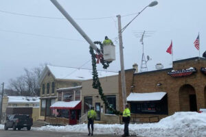 Family Tree removing Christmas decorations for Town of Eagle.